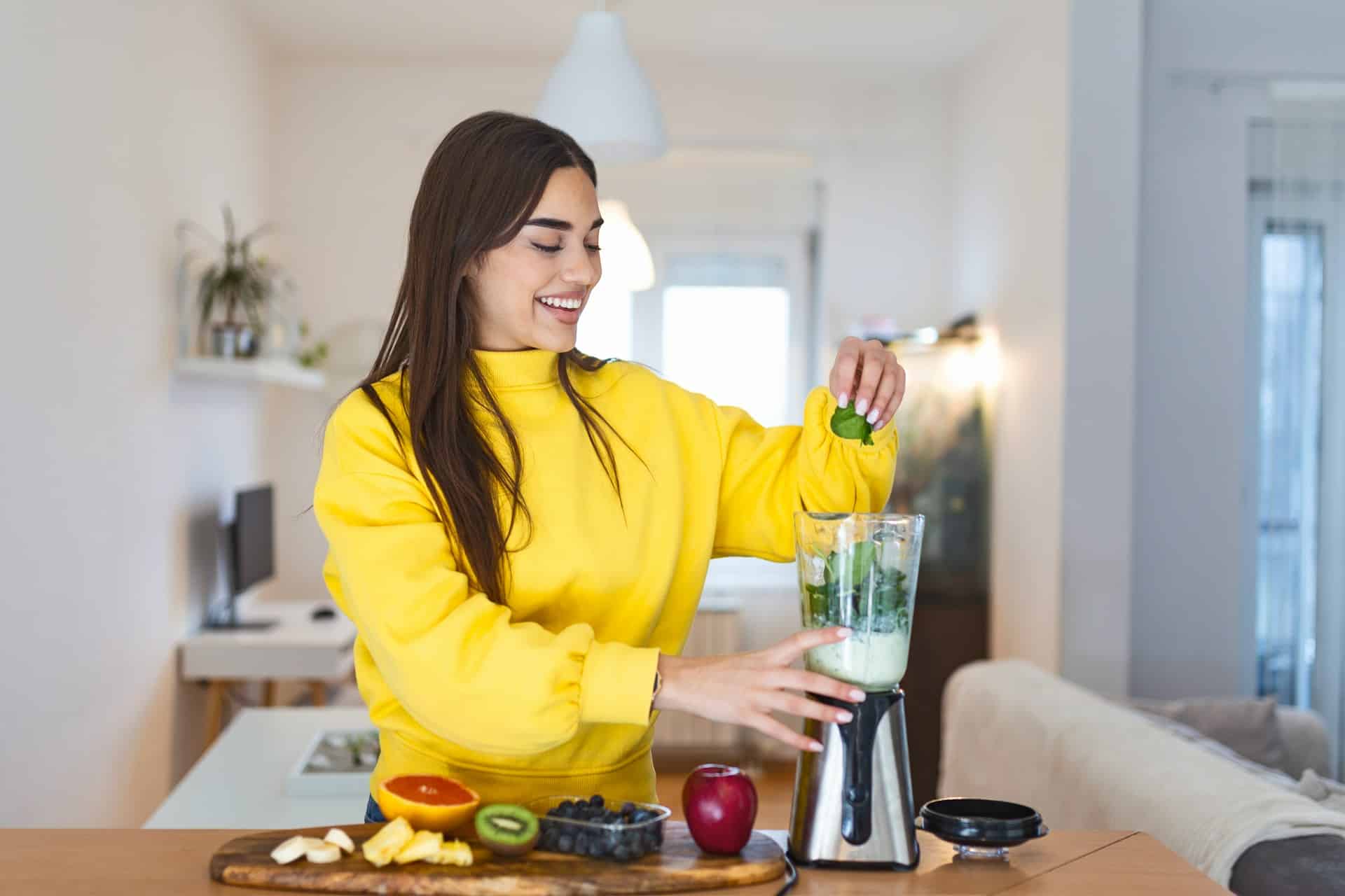 woman making healthy smoothie
