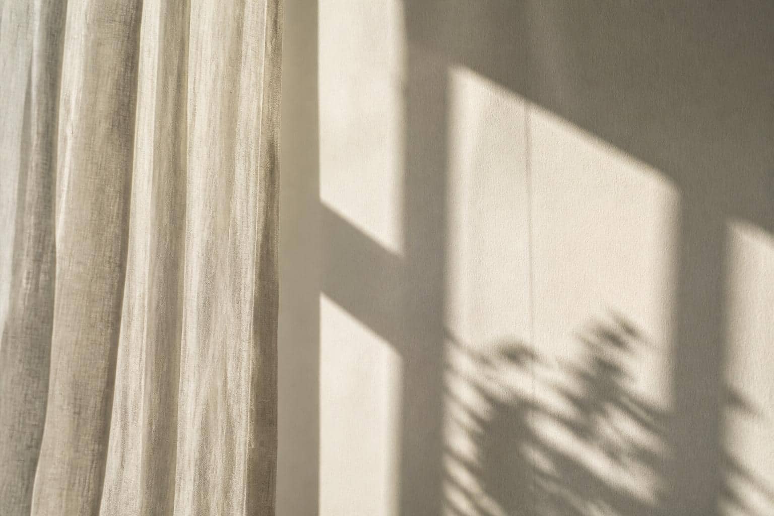 Soft morning light through sheer curtains in a calm clinic room
